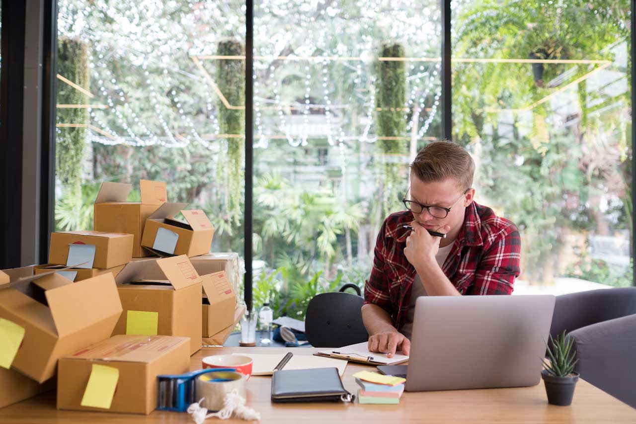 business owner looking at empty boxes